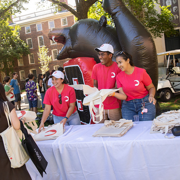 Bruno leaders hand out bags at campus reproduce fair. Photos of the first-year students around campus for small group meetings and the campus resource fair