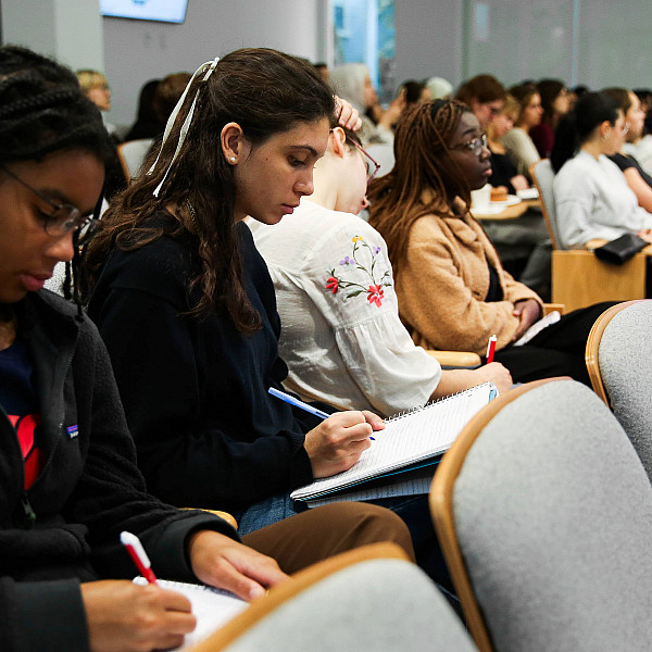 Students taking notes at an event at the Watson Institute.