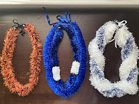 Three yarn leis.